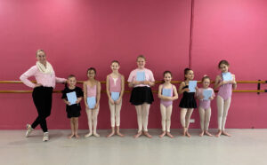 A group of dancers posing with their journals at the end of Winter School at EBA.